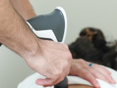 Instrument-assisted adjustment close-up at Vertebre Chiropractic Studio