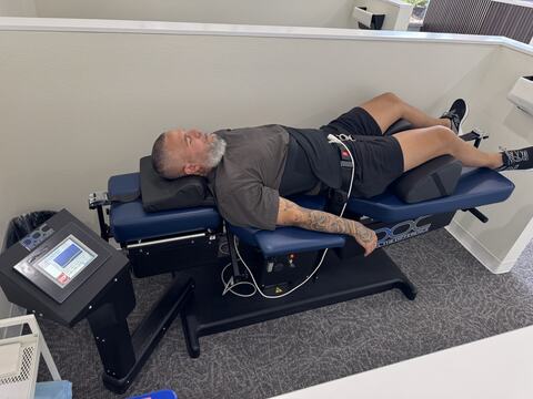 A patient on the spinal decompression table at Vertebre Chiropractic Studio