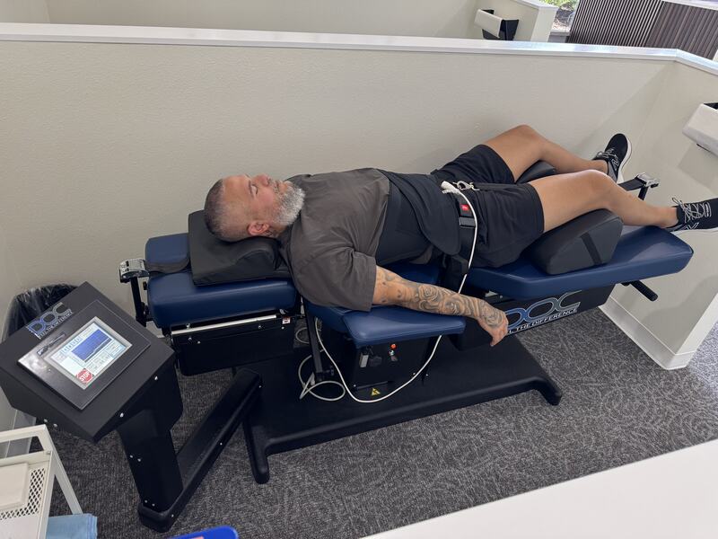 A patient on the spinal decompression table at Vertebre Chiropractic Studio in Winter Garden